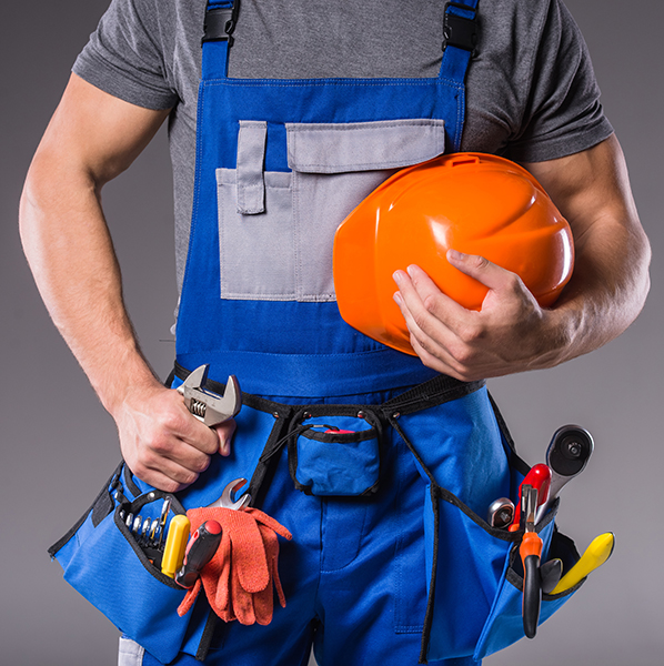Builder with tools in hand to build on gray background.